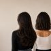 Three women displaying some of the most requested haircuts for women in San Antonio in 2026, featuring long layers, a wavy bob, and a classic blunt bob in a modern, minimalist beauty salon aesthetic.