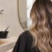 JC BALAYAGE SAN ANTONIO stylist hand painting balayage highlights on dark brunette hair during color consultation