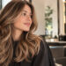 San Antonio woman smiling confidently after fresh haircut and color service at local hair salon